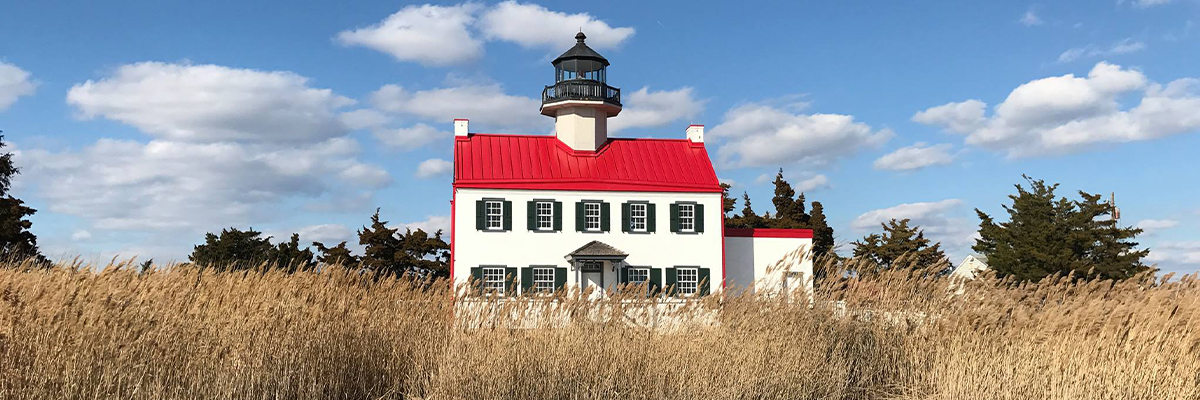 Red Roofed House with Lighthouse style light on top : Photo